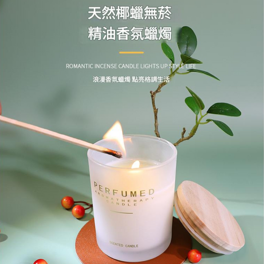 Perfumed candle being lit with a wooden match, surrounded by greenery on a light green background.