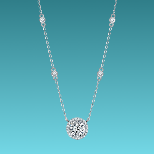 Silver necklace with a round diamond pendant on a teal background